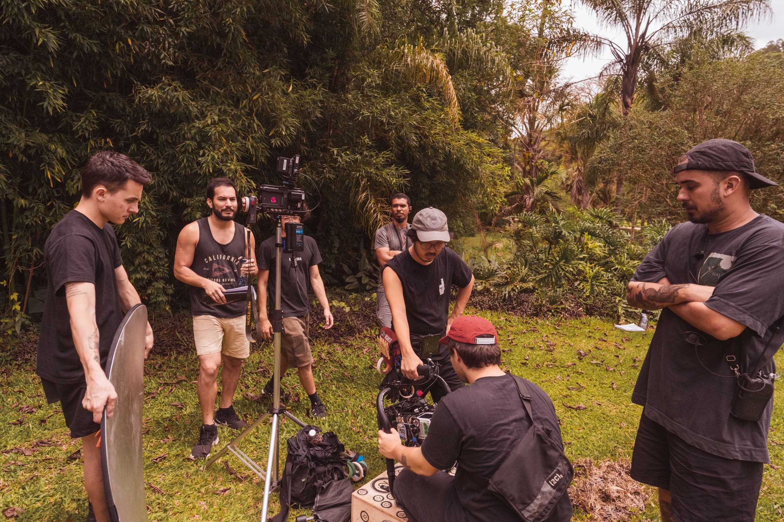 A film crew interviewing a subject on location outside a working facility at golden hour