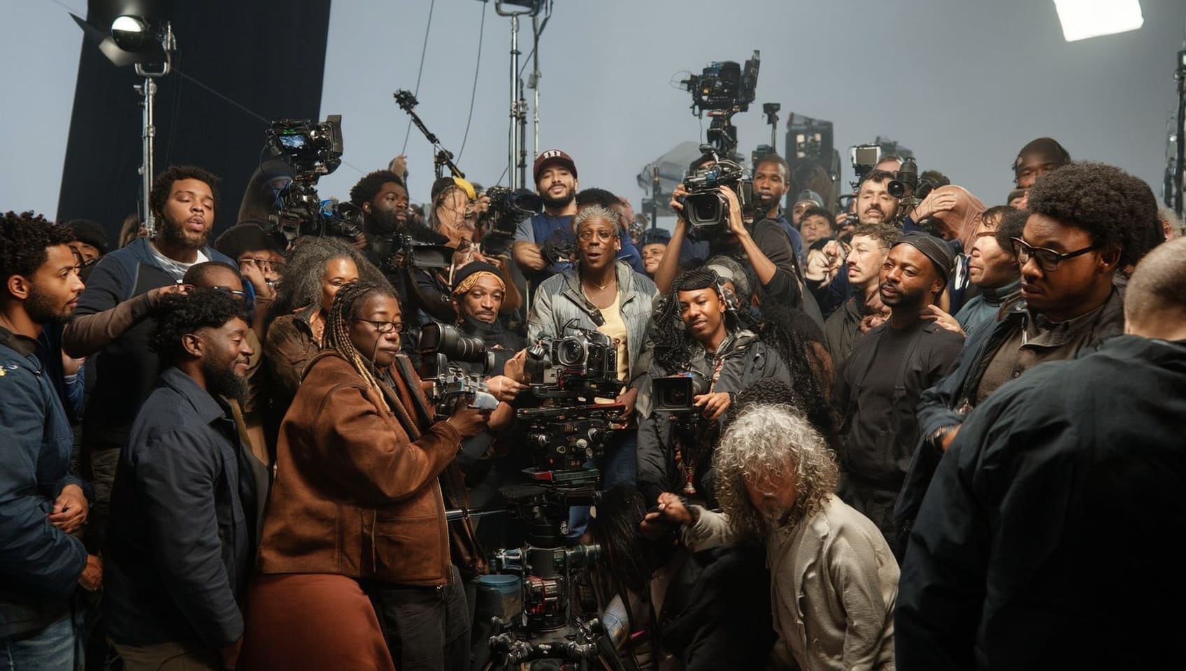 A full crew of camera operators and directors gathered on a studio set between takes